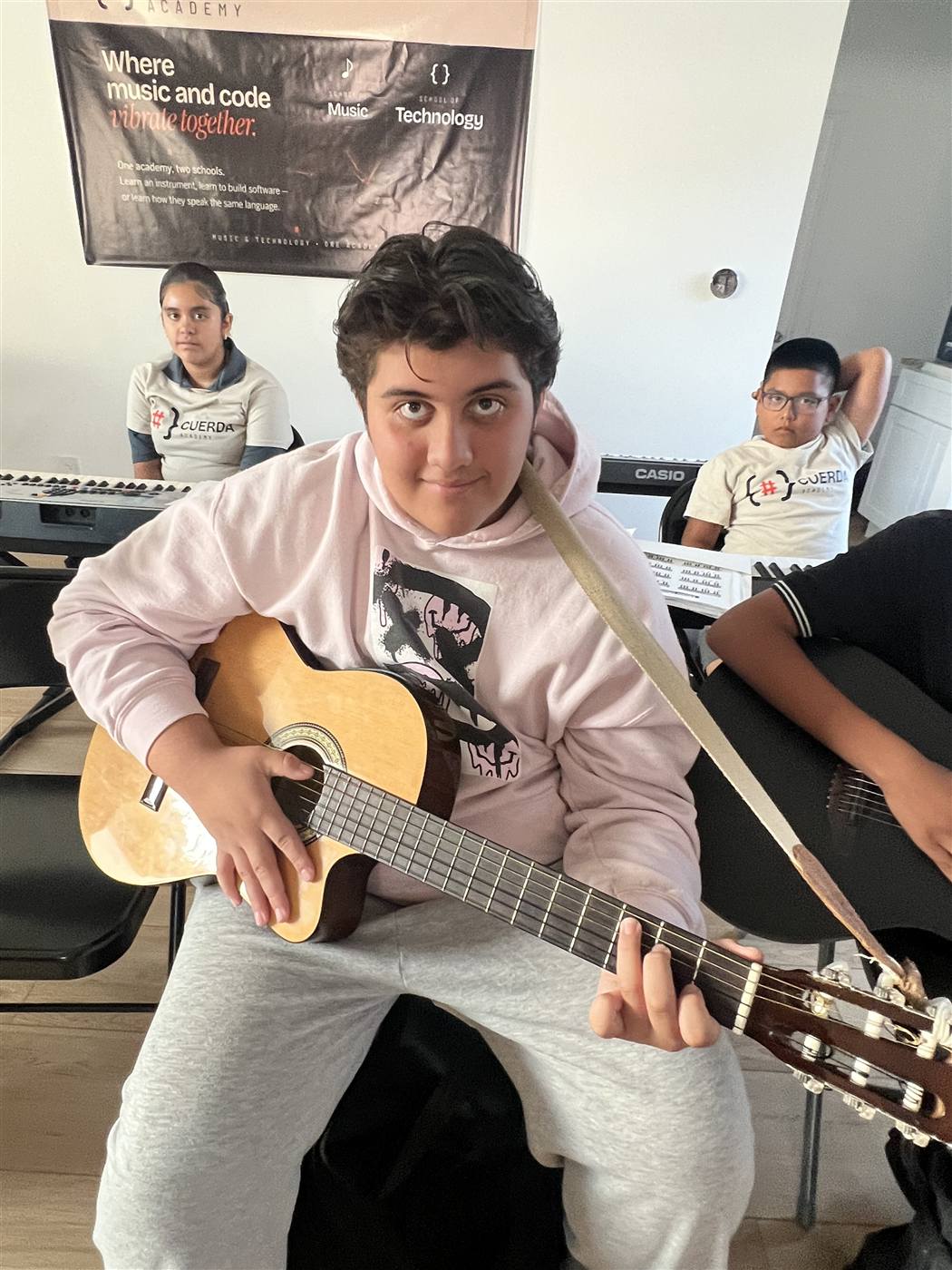 Student practicing classical guitar in class