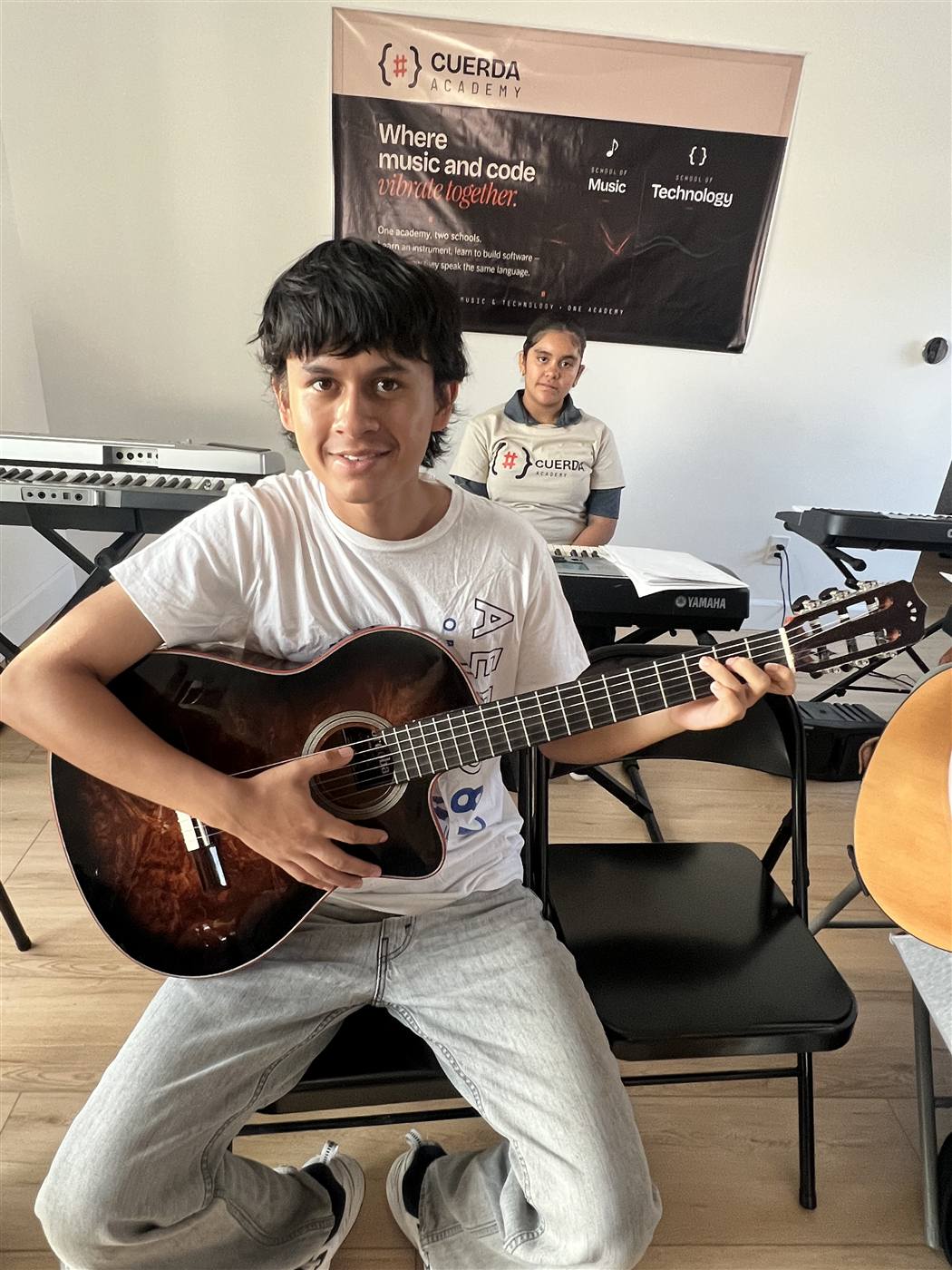Student with his guitar in the classroom